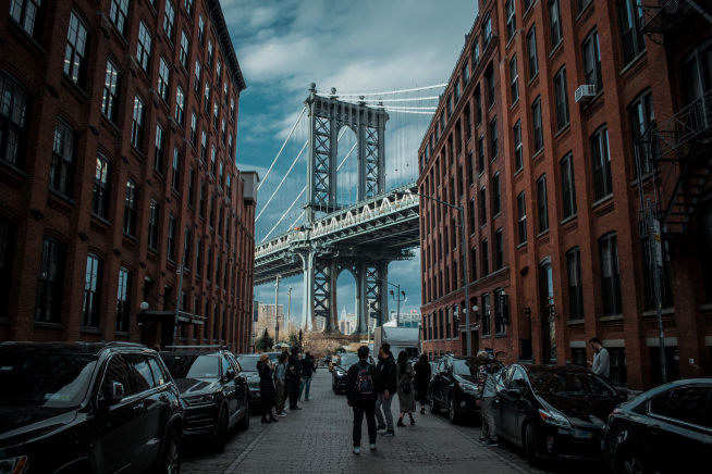 New York city street with bridge and student group