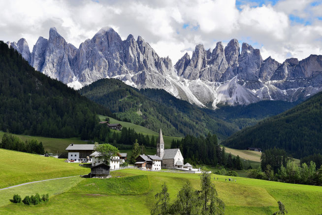 international program in the Swiss Alps with green hills and church